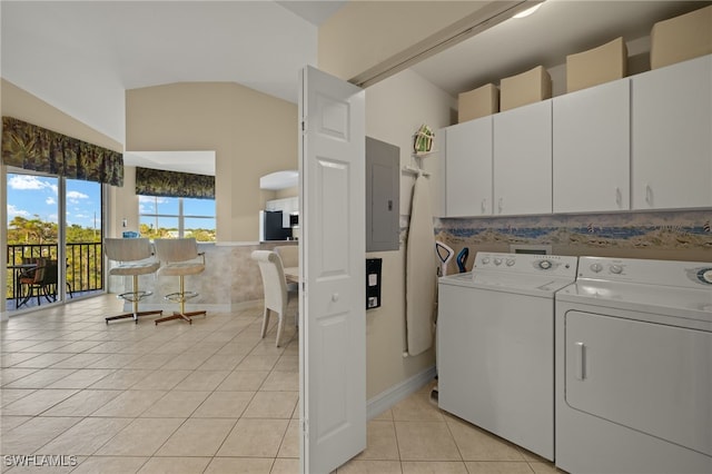 laundry area featuring cabinets, light tile patterned flooring, independent washer and dryer, and electric panel