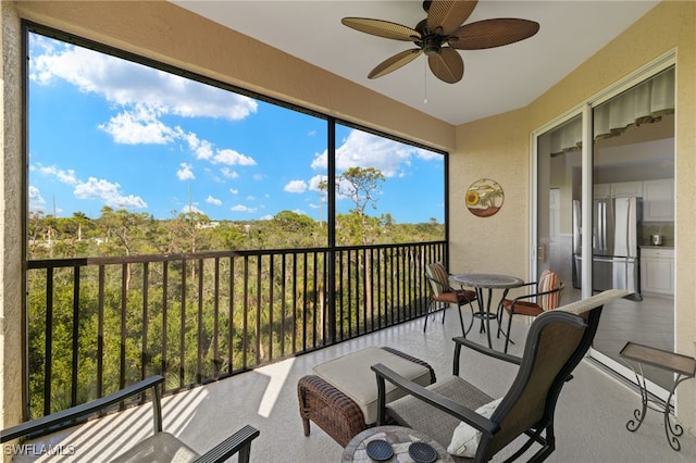 sunroom featuring ceiling fan