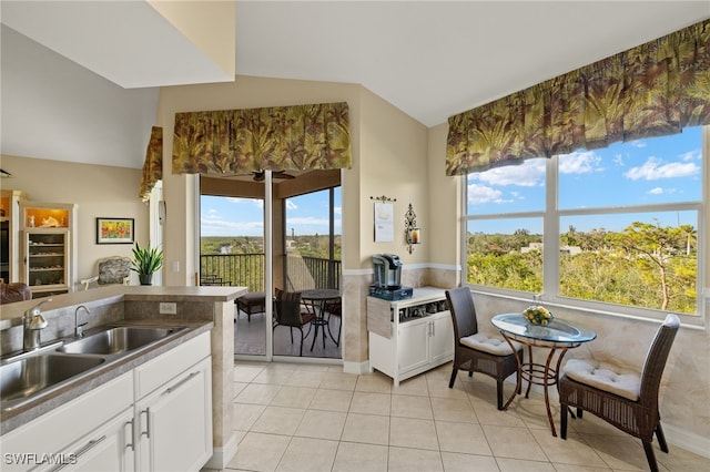 kitchen with sink, white cabinets, and light tile patterned flooring