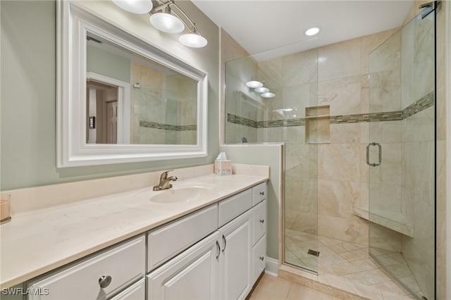 bathroom featuring tile patterned floors, walk in shower, and vanity