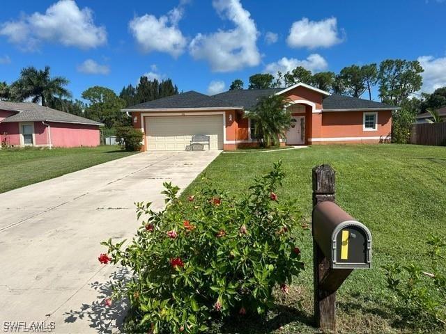 single story home with a front yard and a garage