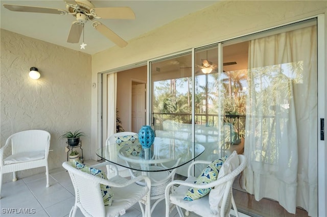 sunroom / solarium featuring ceiling fan