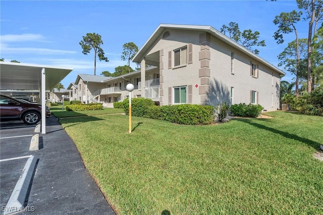 view of home's exterior with a carport and a lawn