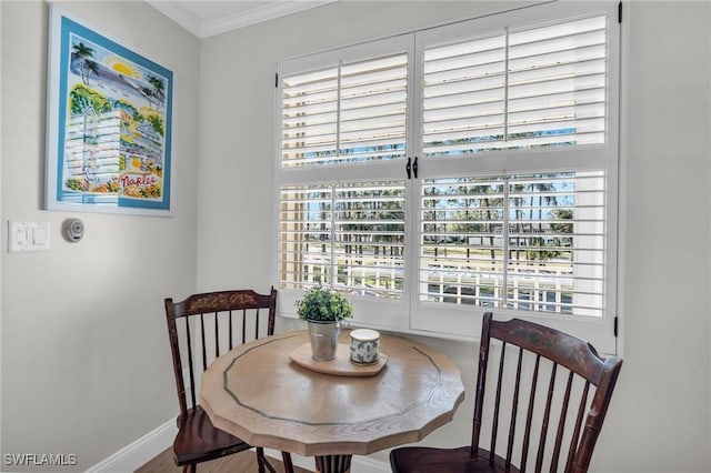 dining space with hardwood / wood-style floors, plenty of natural light, and ornamental molding