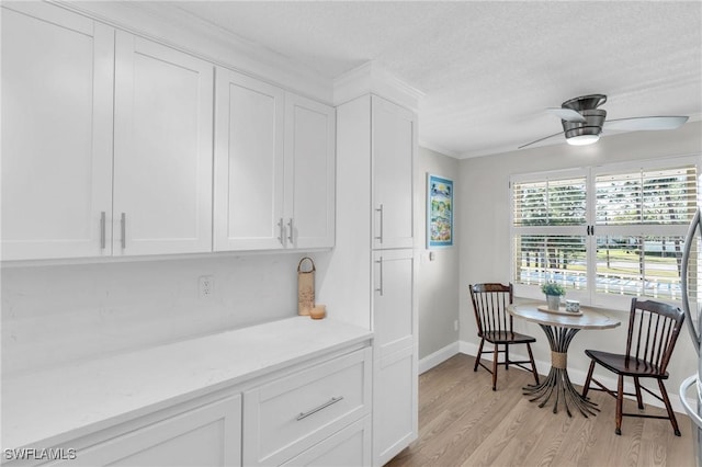 dining area featuring crown molding, ceiling fan, and light hardwood / wood-style floors