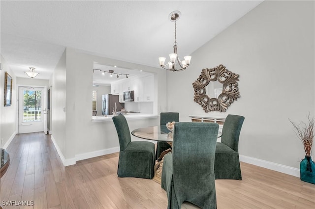 dining space featuring a chandelier and light wood-type flooring