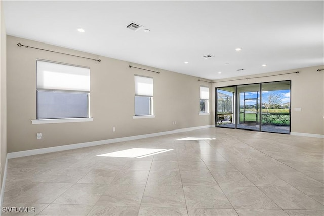 spare room with recessed lighting, visible vents, and baseboards