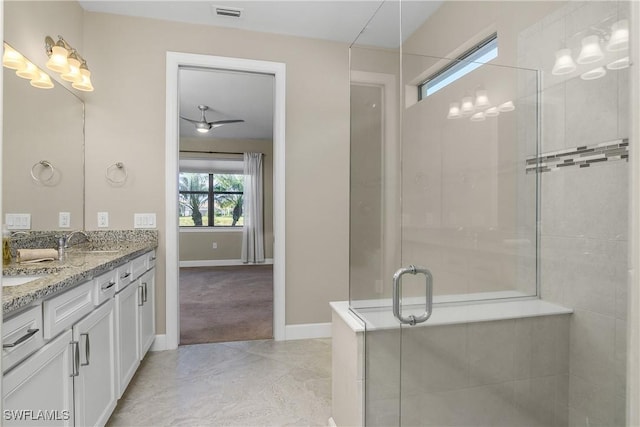 bathroom featuring tile patterned flooring, vanity, and a shower with door