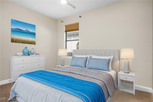 carpeted bedroom featuring ceiling fan and baseboards