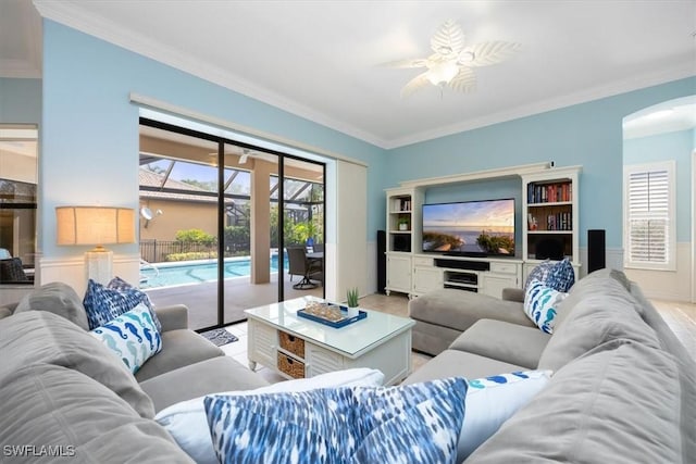 living room featuring crown molding and ceiling fan