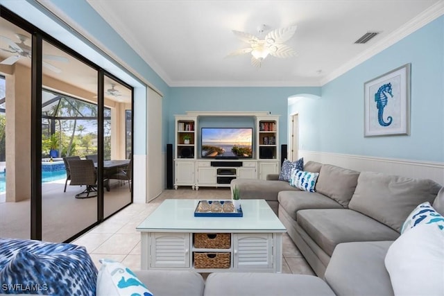 tiled living room featuring crown molding and ceiling fan