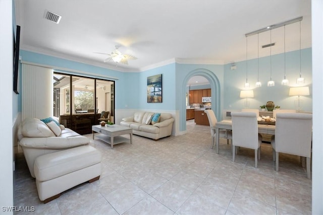 tiled living room featuring crown molding and ceiling fan