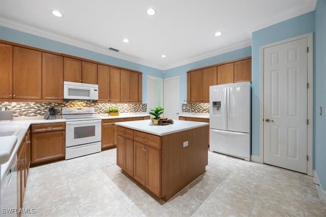 kitchen featuring white appliances, ornamental molding, decorative backsplash, and a kitchen island