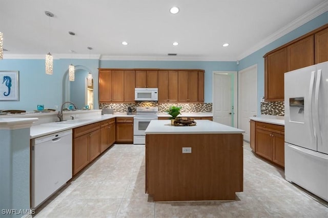 kitchen with sink, hanging light fixtures, a center island, kitchen peninsula, and white appliances