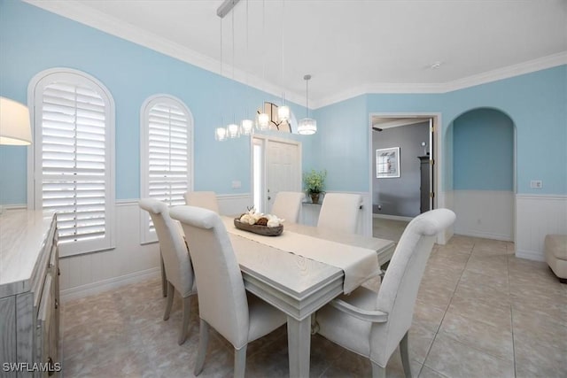 tiled dining area featuring ornamental molding