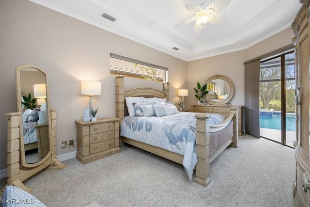 carpeted bedroom with ceiling fan, ornamental molding, a tray ceiling, and access to outside