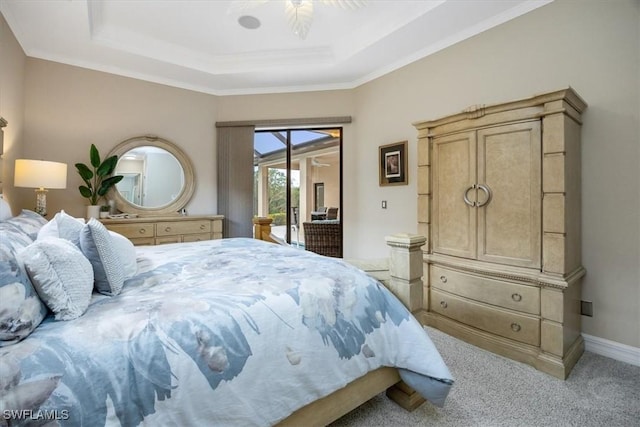 bedroom with light carpet, access to exterior, a tray ceiling, and crown molding