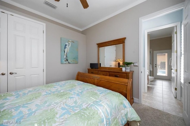 tiled bedroom with ornamental molding and ceiling fan