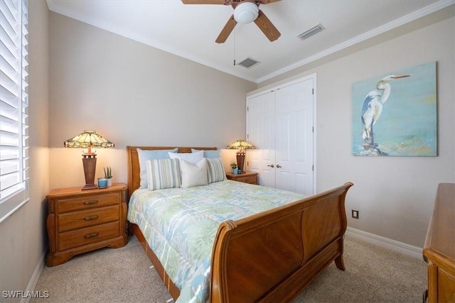 bedroom with baseboards, visible vents, a closet, and light colored carpet