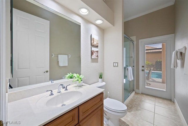 bathroom featuring tile patterned flooring, vanity, a shower with shower door, and toilet