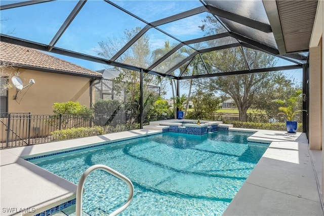 view of swimming pool featuring a pool with connected hot tub, fence, and a patio