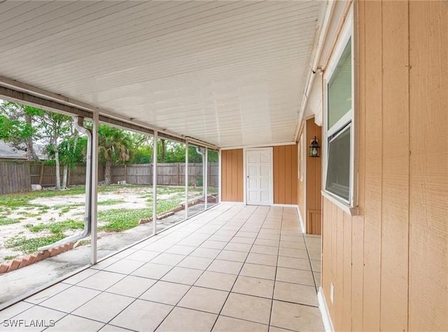 unfurnished sunroom featuring vaulted ceiling