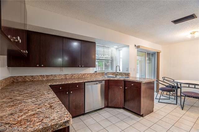 kitchen featuring dishwasher, dark brown cabinets, a textured ceiling, and sink