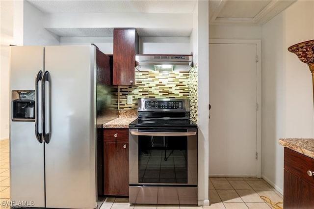 kitchen with backsplash, exhaust hood, light stone countertops, appliances with stainless steel finishes, and light tile patterned flooring