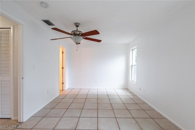 tiled empty room with ceiling fan