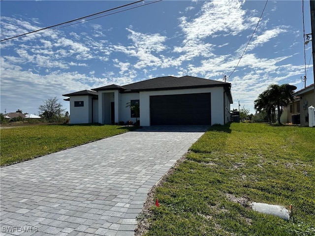 view of front of home with a front yard and a garage