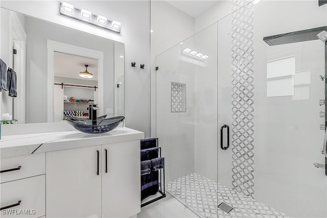 bathroom featuring vanity and an enclosed shower