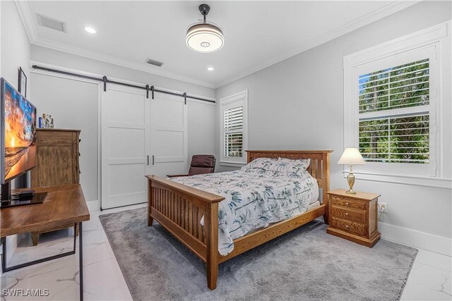 bedroom featuring a barn door, a closet, and crown molding