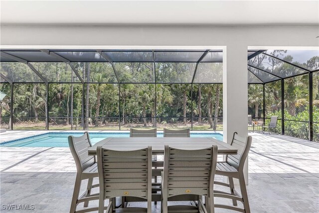 view of patio featuring a lanai