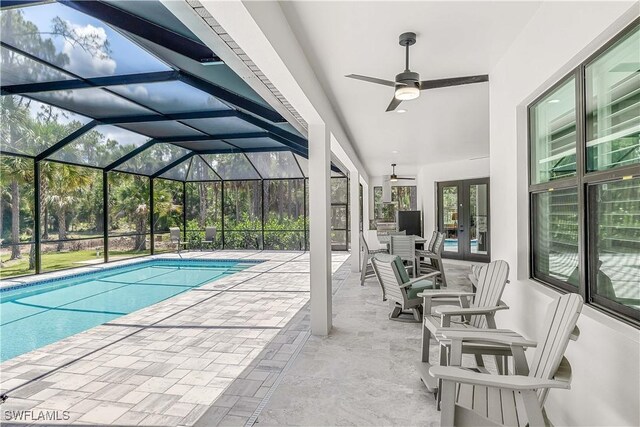 view of pool featuring ceiling fan, a patio area, a lanai, and french doors