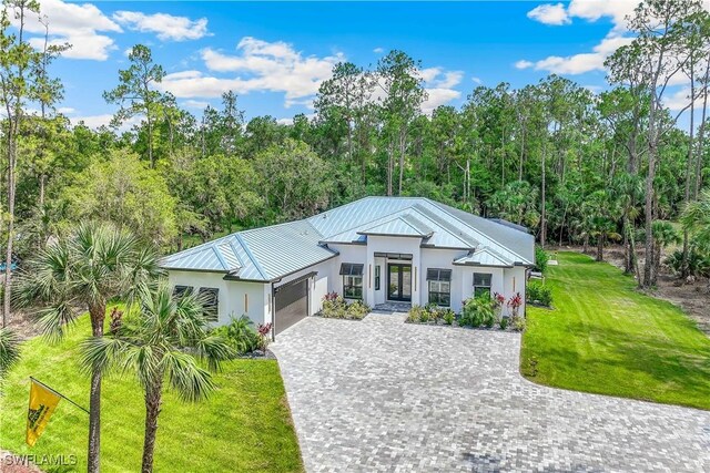 view of front of house featuring a front lawn and a garage