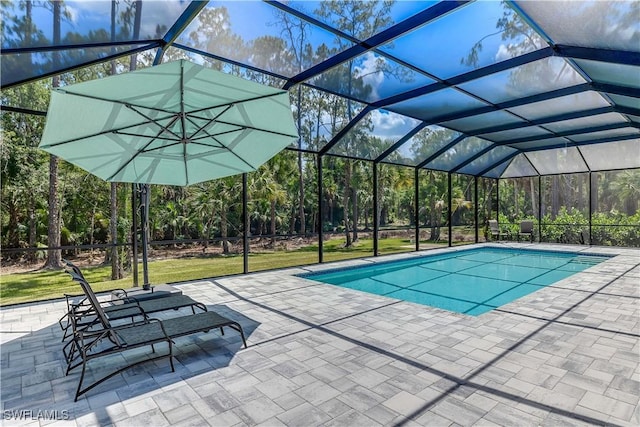 view of swimming pool featuring a patio area and a lanai