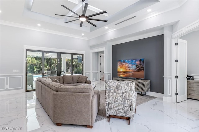 living room with a tray ceiling, ceiling fan, french doors, and ornamental molding