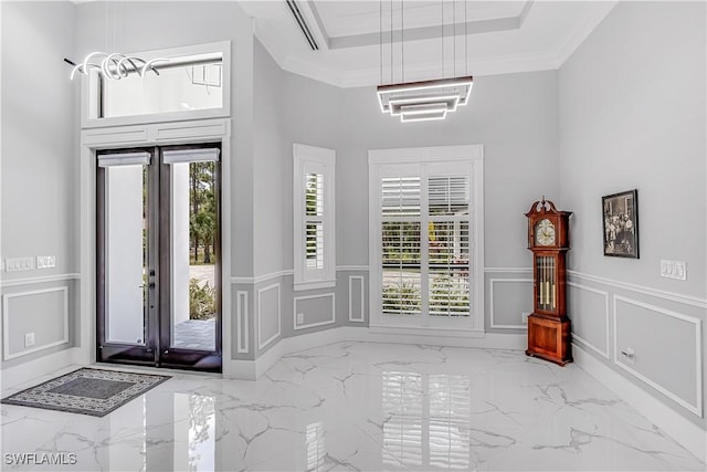 foyer entrance featuring plenty of natural light and ornamental molding