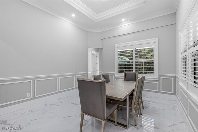 dining room featuring a tray ceiling and ornamental molding