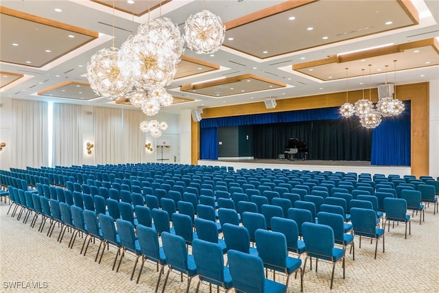 cinema featuring an inviting chandelier and coffered ceiling