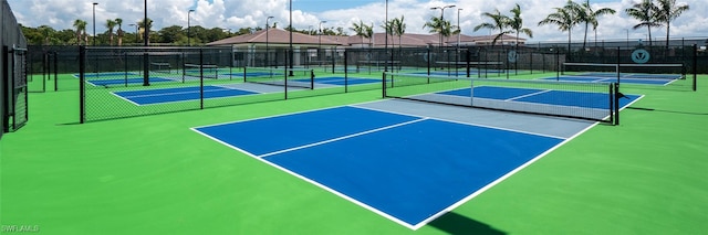 view of tennis court with basketball hoop