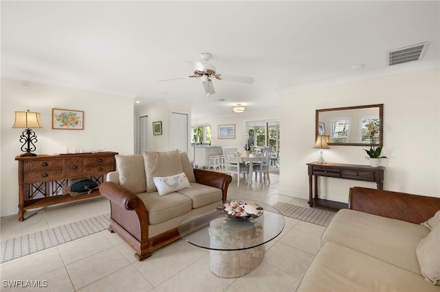 tiled living room with crown molding and ceiling fan