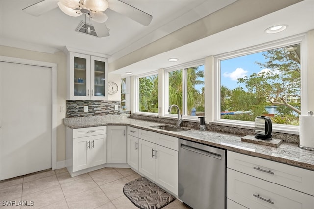 kitchen with white cabinets, dishwasher, light stone counters, and sink