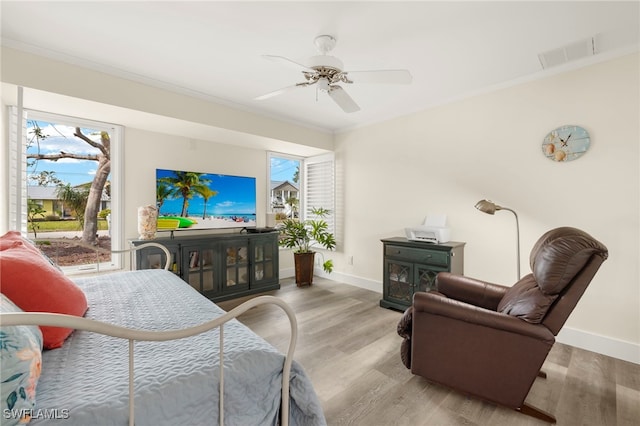 bedroom with ceiling fan, light hardwood / wood-style floors, and ornamental molding