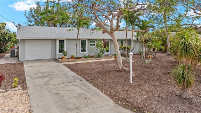 ranch-style home with central AC and a garage