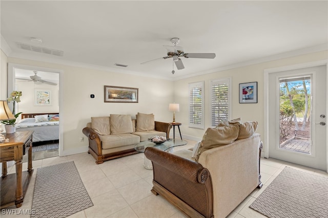 living room featuring light tile patterned floors, ceiling fan, and ornamental molding