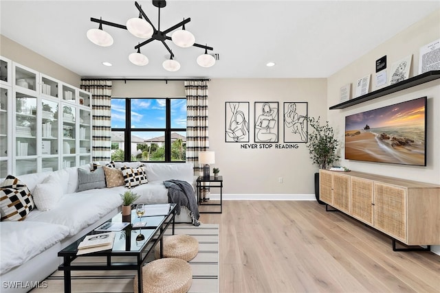 living room with a chandelier and light wood-type flooring