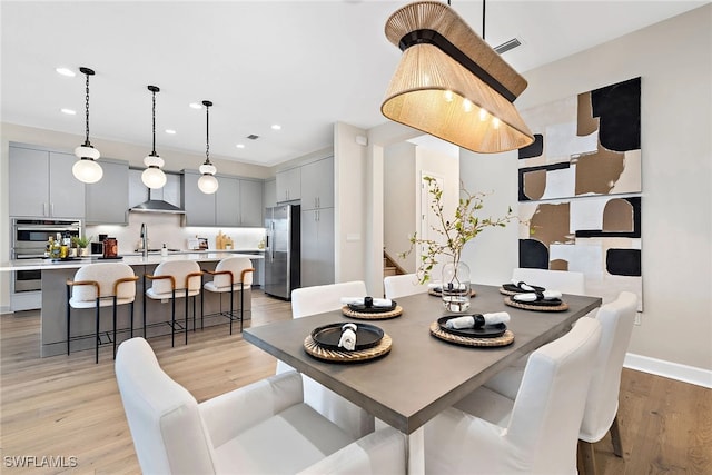 dining area featuring light hardwood / wood-style floors and sink