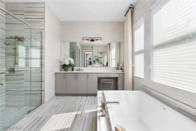 bathroom with separate shower and tub and vanity