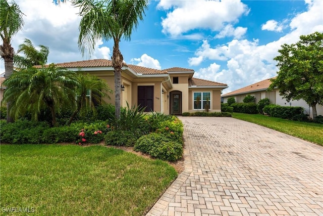 mediterranean / spanish home featuring a front yard